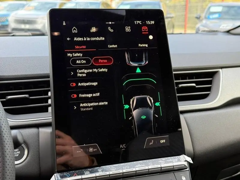 Écran tactile central du tableau de bord du Renault Captur 2025 affichant les aides à la conduite en mode hybride.