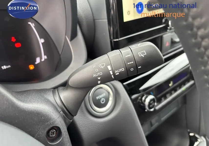 Gros plan intérieur sur la commande d’essuie-glace et le bouton start/stop d’une Toyota Yaris Cross gris atlas.