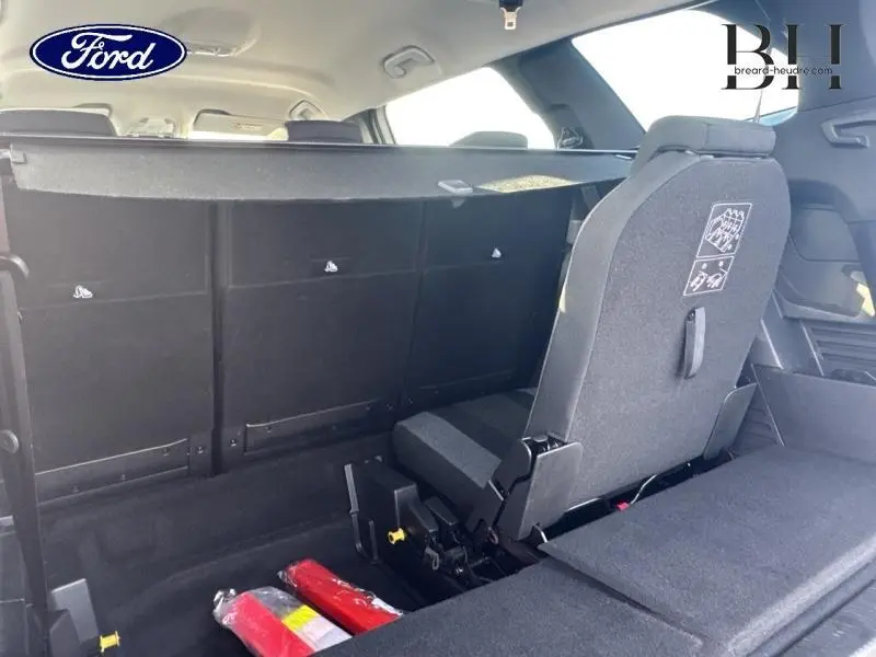 Vue arrière intérieure du Peugeot 5008 blanc Banquise, mettant en valeur les sièges arrière modulables et le coffre spacieux.