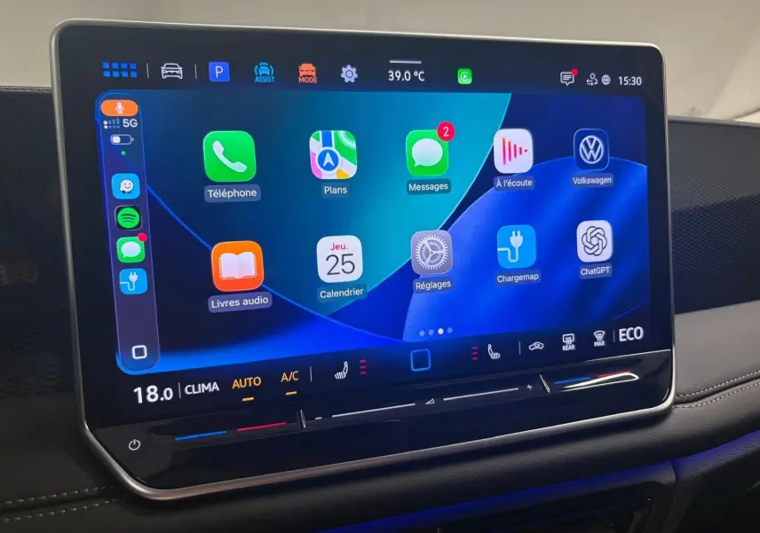 Écran tactile central du Volkswagen Tiguan 2025 affichant des applications et commandes climatisation, intérieur noir moderne.