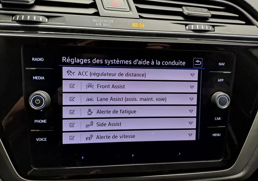 Écran tactile du système d’aide à la conduite du Volkswagen Touran 2025, affichant les réglages des assistances.