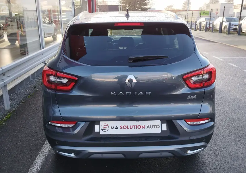 Vue arrière d'un Renault Kadjar gris titanium 2021 avec feux LED et badge 4x4 visible sur un parking.