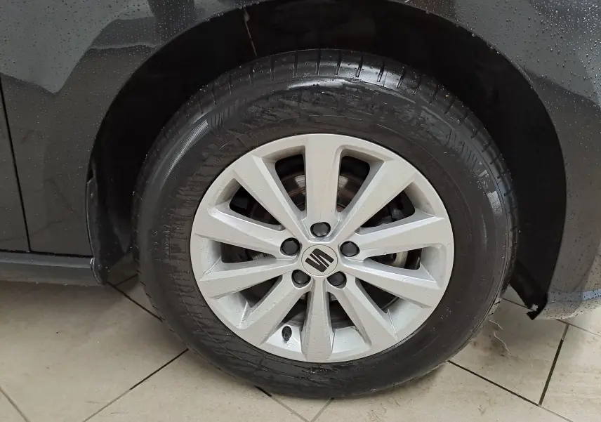 Gros plan sur la jante alliage 15'' Enjoy argentée du côté avant droit d'une SEAT Ibiza noir minuit 2024.