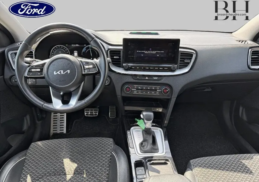 Vue intérieure avant du Kia Xceed 2022 avec volant cuir, écran tactile et levier de vitesse automatique.