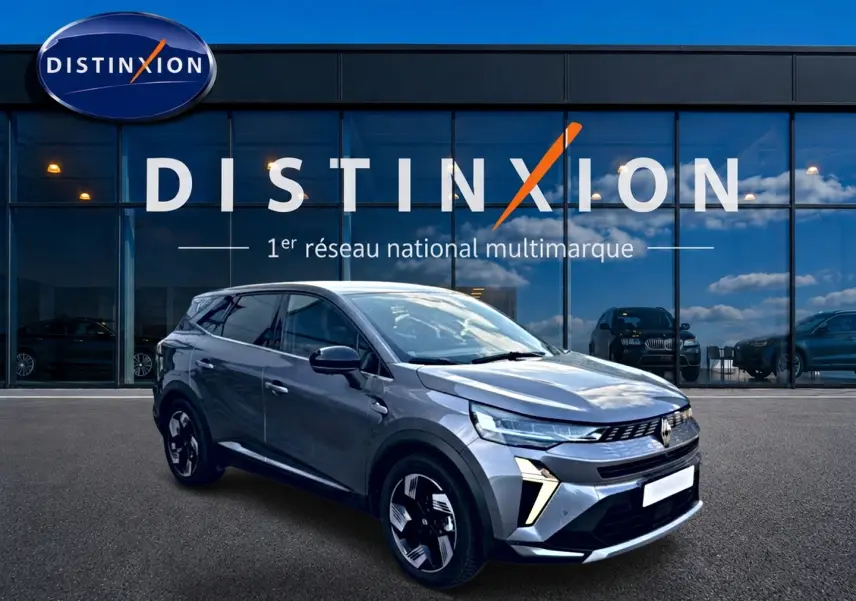 Renault Symbioz gris 3/4 avant droit, SUV hybride avec signature lumineuse distinctive et jantes modernes.