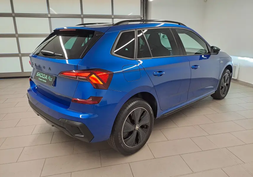 Vue 3/4 arrière droite du Skoda Kamiq 1.5 TSI 150 DSG7 Monte Carlo en bleu RS avec jantes noires distinctives.