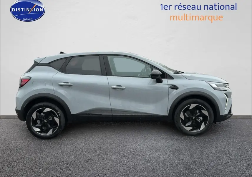 Profil côté gauche du Renault Captur gris rafale 2025 avec jantes alliage noires et toit noir contrasté.