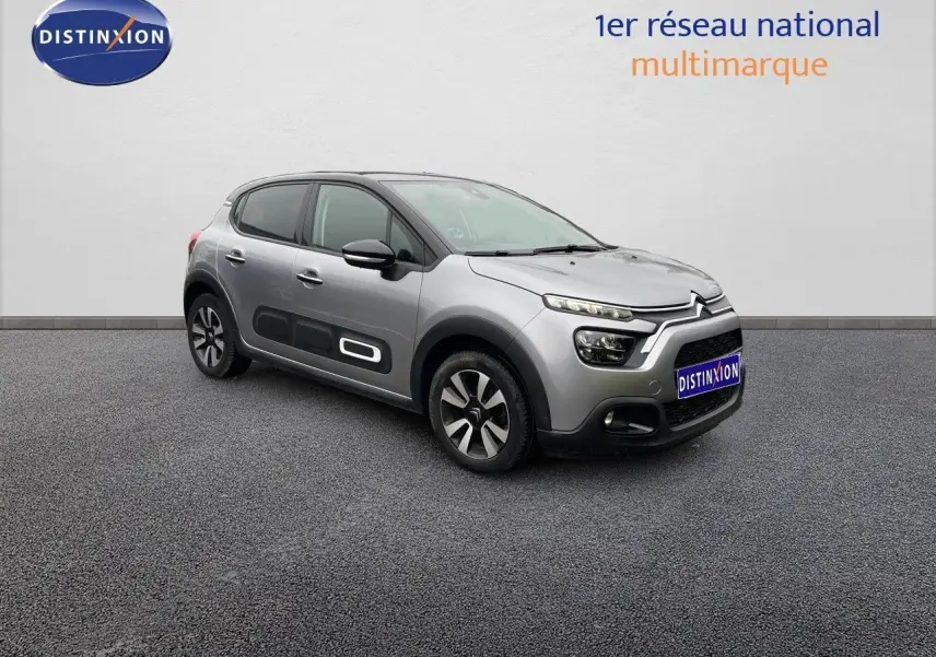 Citroën C3 gris acier métal vue 3/4 avant droit, avec protections latérales noires et jantes bi-ton.