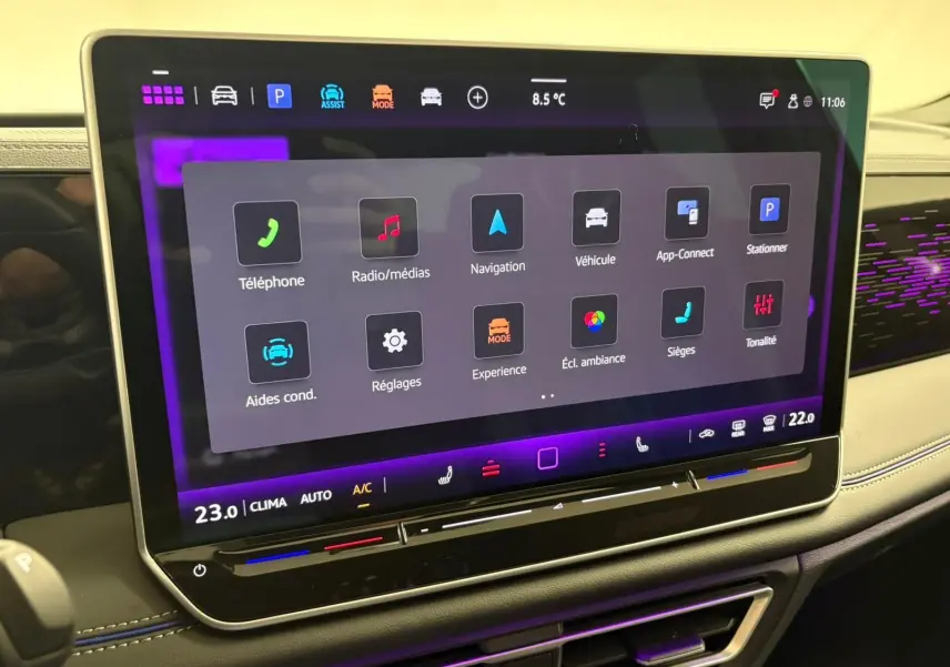 Écran tactile 15 pouces du Volkswagen Tiguan 2024 avec interface multimédia et ambiance lumineuse violette.