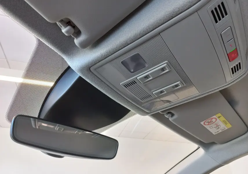 Vue intérieure du toit avec rétroviseur et console de plafonnier gris clair dans une SEAT Ibiza bleu saphir 2025.