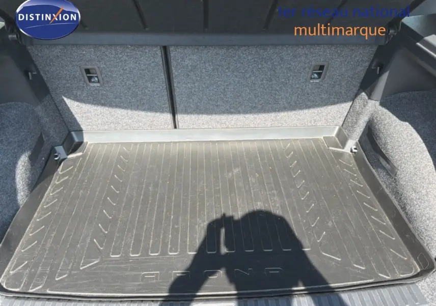 Vue intérieure du coffre du SEAT Arona gris urbain, montrant le tapis de protection en caoutchouc.