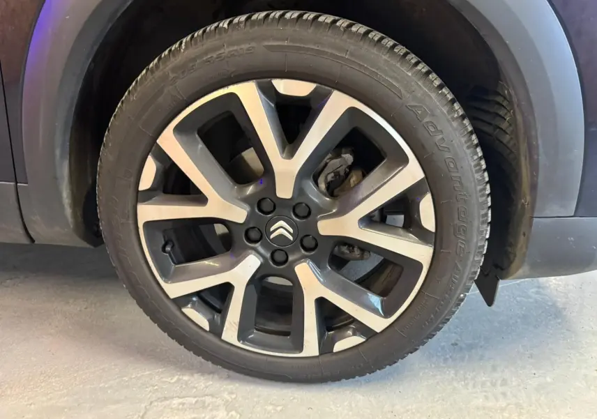 Vue intérieure de la porte avant gauche du Citroën C5 Aircross bleu, avec poignée et commandes visibles.