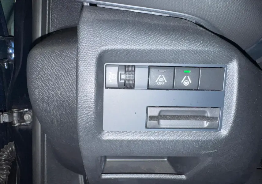 Gros plan sur les commandes du volant noir du Citroën C5 Aircross 2022, avec écran numérique en arrière-plan.