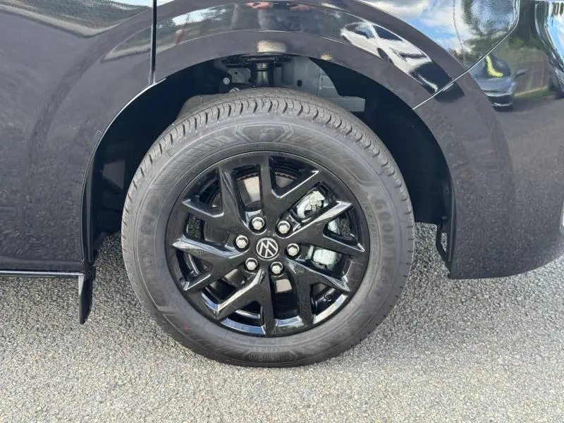 Gros plan sur la roue avant droite noire brillante du Volkswagen Transporter Procab Midnight Black métallisé.