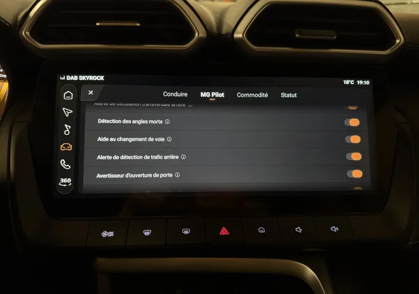 Écran tactile central du MG ZS 2026 affichant les options d'aide à la conduite, entouré de commandes et aérateurs noirs.