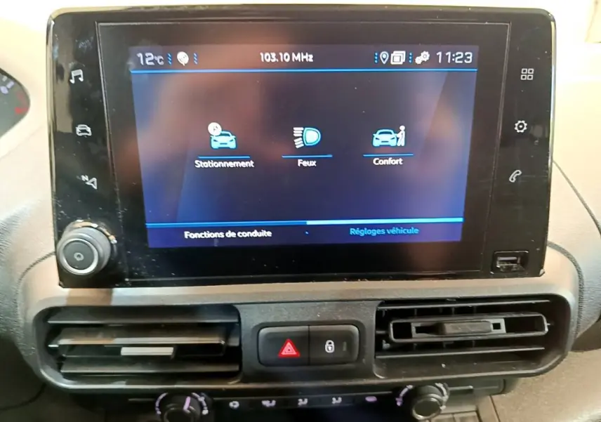 Vue rapprochée de l’écran tactile central du Peugeot Partner noir 2022 affichant les réglages de conduite.