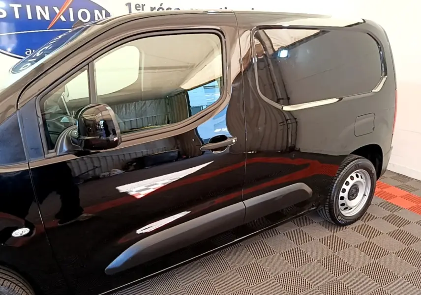 Profil côté gauche du Peugeot Partner noir 2022 avec porte latérale coulissante et jantes acier simples.