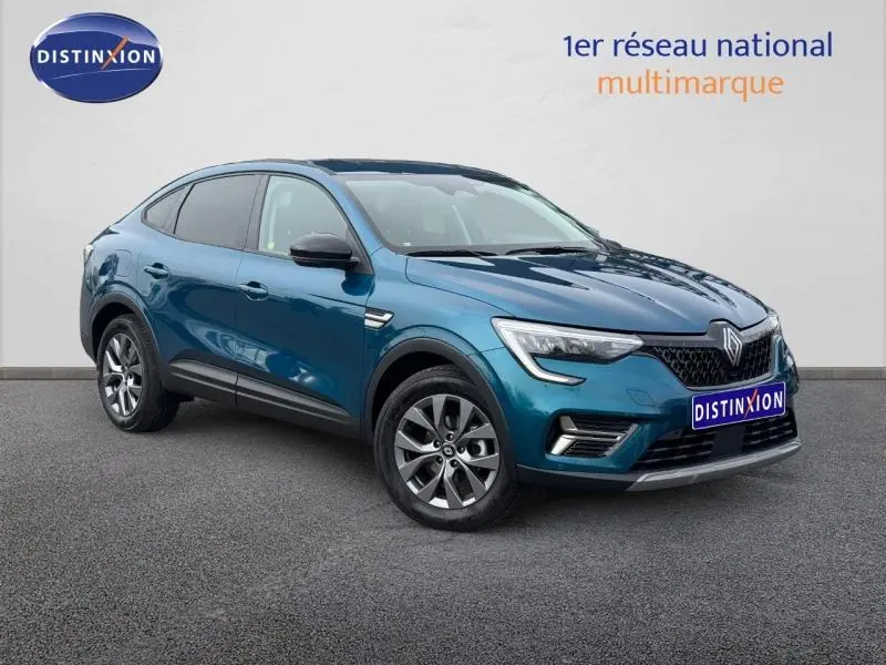 Renault Arkana bleu Zanzibar en 3/4 avant droit, SUV hybride essence avec calandre noire et jantes alliage.