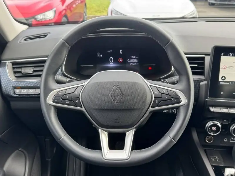 Vue rapprochée du volant multifonction noir du Renault Arkana 2025, avec tableau de bord numérique et console centrale visible.