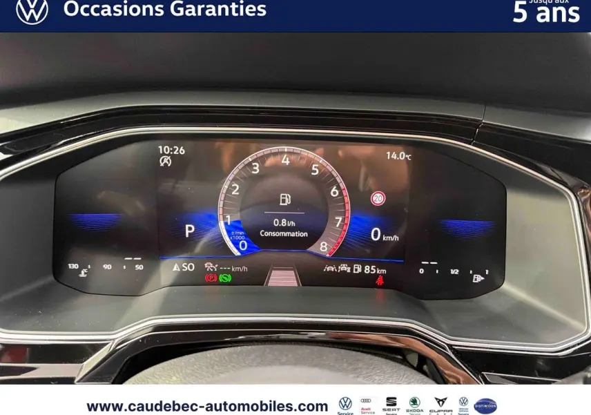 Vue rapprochée du combiné d'instruments digital de la Volkswagen Polo rouge, affichant la consommation et la vitesse à 0 km/h.