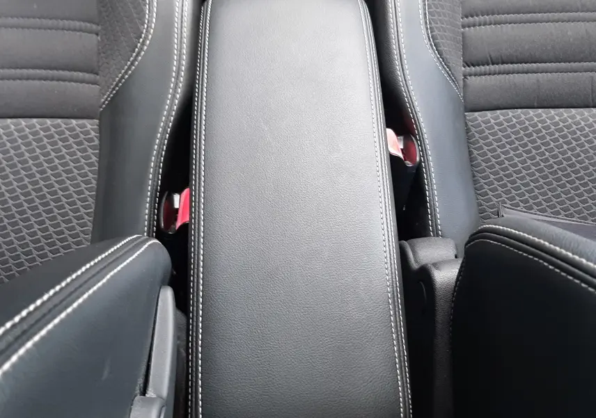 Vue plongeante sur l'accoudoir central en cuir noir avec surpiqûres blanches du Renault Grand Scenic DCI 110 Bose 7 places.