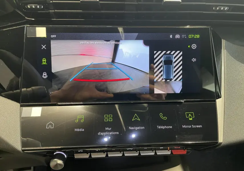Écran tactile central de la Peugeot 308 bleu montrant la caméra de recul et l'interface multimédia.