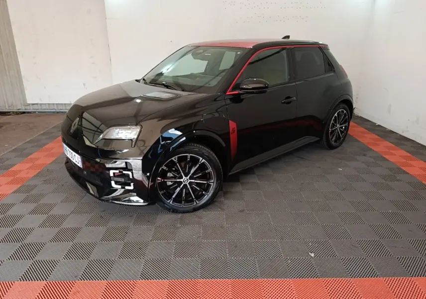 Renault R5 Iconic 2024 vue 3/4 avant côté gauche, carrosserie noire avec toit et détails rouges, jantes noires stylées.