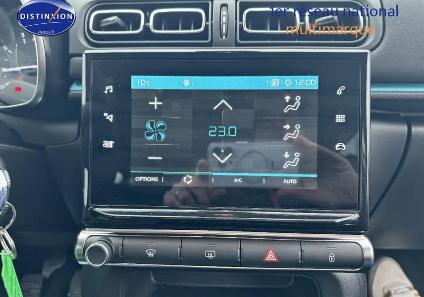 Vue rapprochée de la console centrale de la Citroën C3 gris acier 2023, avec écran tactile et commandes climatisation.