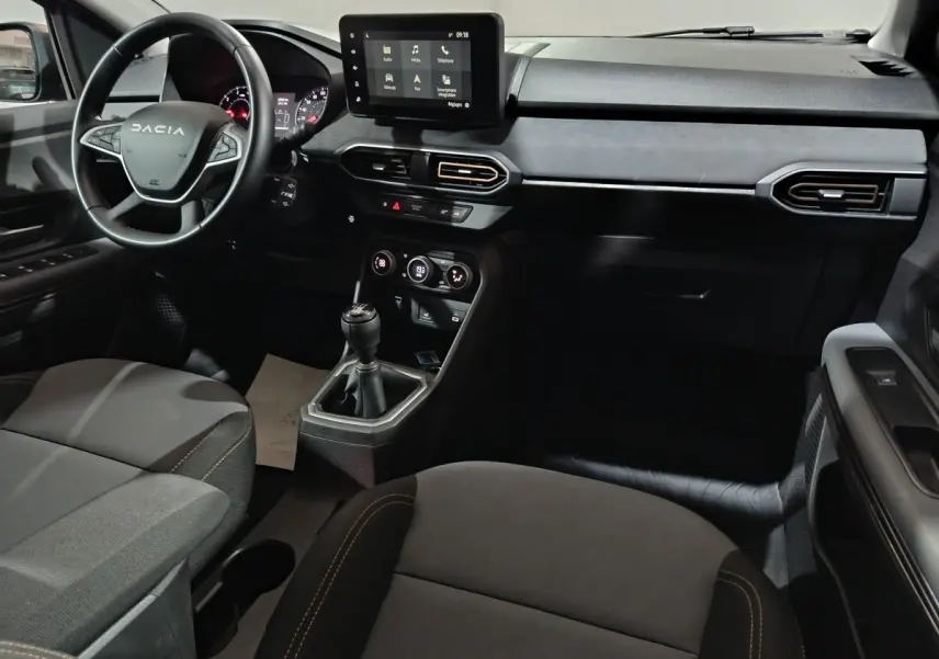 Intérieur de la Dacia Sandero Extreme+ 2024, vue côté conducteur, tableau de bord noir avec écran tactile central.