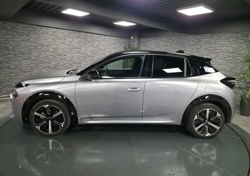 Vue de profil côté gauche d'une Lancia Ypsilon 2025 gris métallisé avec toit noir et jantes alliage 17 pouces.