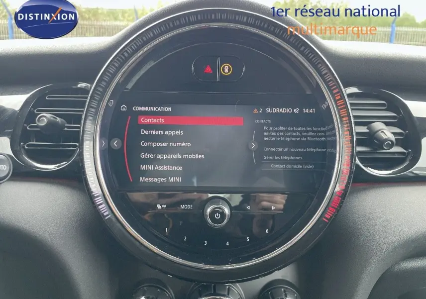 Tableau de bord de MINI 2023 avec écran central rond affichant menu communication, entouré d'aérations noires.