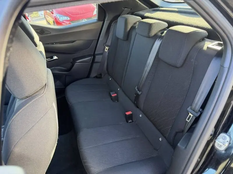 Vue intérieure côté droit sur la banquette arrière en tissu noir du DS3 Crossback PureTech 2020, avec ceintures de sécurité visibles.