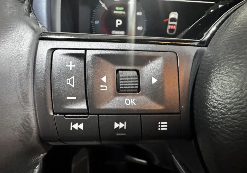 Gros plan sur les commandes multifonctions noires au volant du Nissan Qashqai e-Power 190 Tekna BVA 2023.