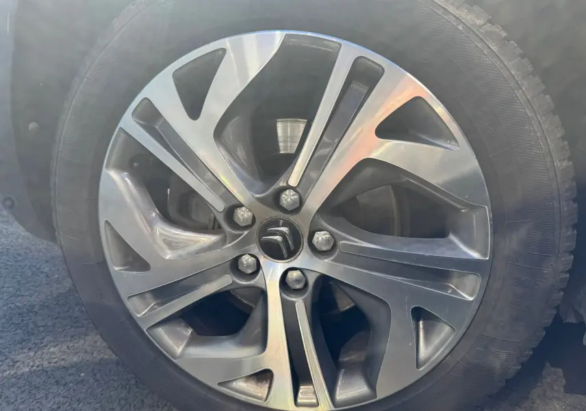 Gros plan sur la jante alu grise d'une Citroën C4 Picasso 2016, avec logo Citroën au centre.