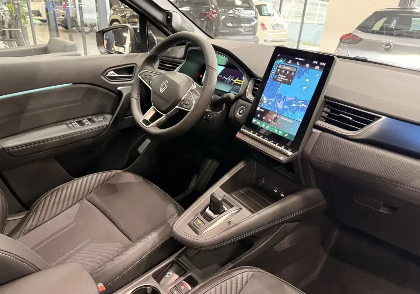 Vue intérieure côté conducteur du Renault Symbioz E-Tech 2026, avec écran tactile vertical et sellerie noire élégante.