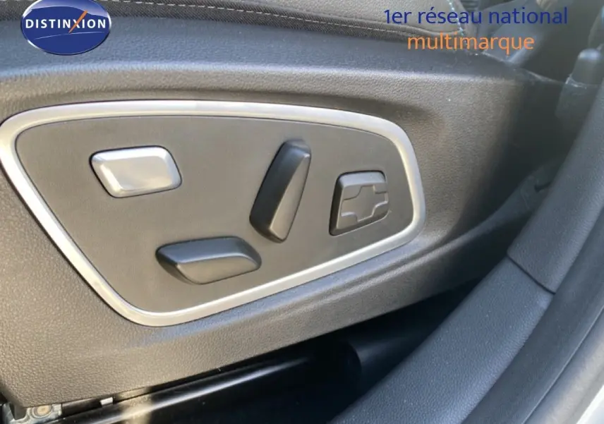 Gros plan sur les commandes électriques du siège conducteur du Renault Austral blanc nacré toit noir 2024.