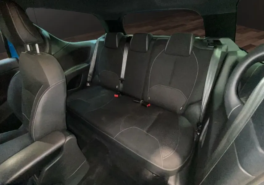 Vue intérieure arrière de la banquette noire de la Citroën DS3 e-HDi 90 Airdream So Chic, avec ceintures visibles.
