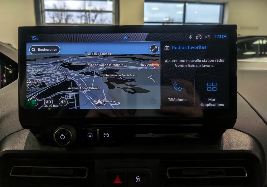 Écran tactile central du Peugeot Rifter 2025 affichant la navigation et les options radio, vue intérieure frontale.