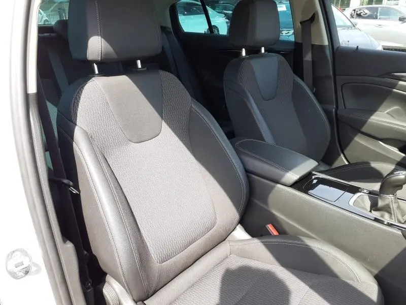 Vue intérieure des sièges avant gris foncé de l'Opel Insignia Grand Sport 2021, avec console centrale et levier de vitesses manuel.
