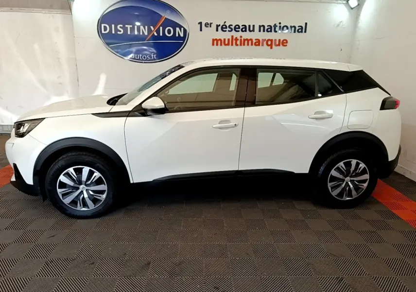 Vue latérale droite d'un Peugeot 2008 blanc de 2021 avec jantes alliage et détails noirs contrastants.