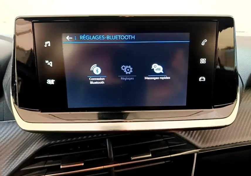 Écran tactile central du tableau de bord du Peugeot 2008 blanc, affichant les réglages Bluetooth.