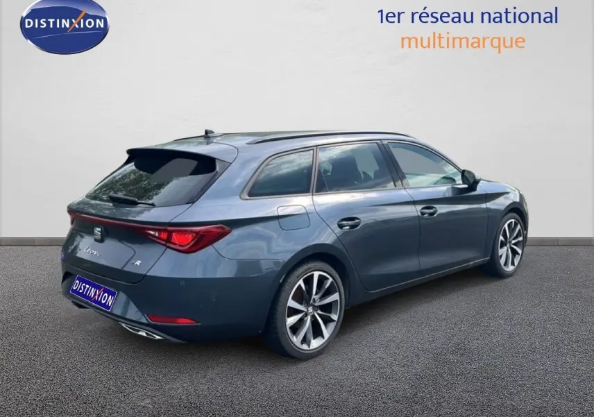 SEAT Leon ST gris magnétique vue 3/4 arrière droit, break hybride essence avec jantes alliage distinctives.