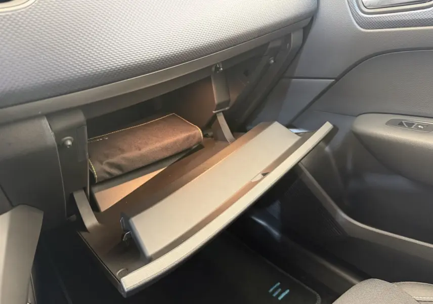 Intérieur de la Renault Arkana Business E-TECH 145 2022, vue sur la boîte à gants ouverte côté passager, finition noire.