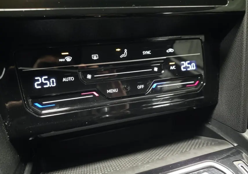 Détail de la console centrale de la Volkswagen Passat SW 2021, affichage numérique de la climatisation à 25°C.