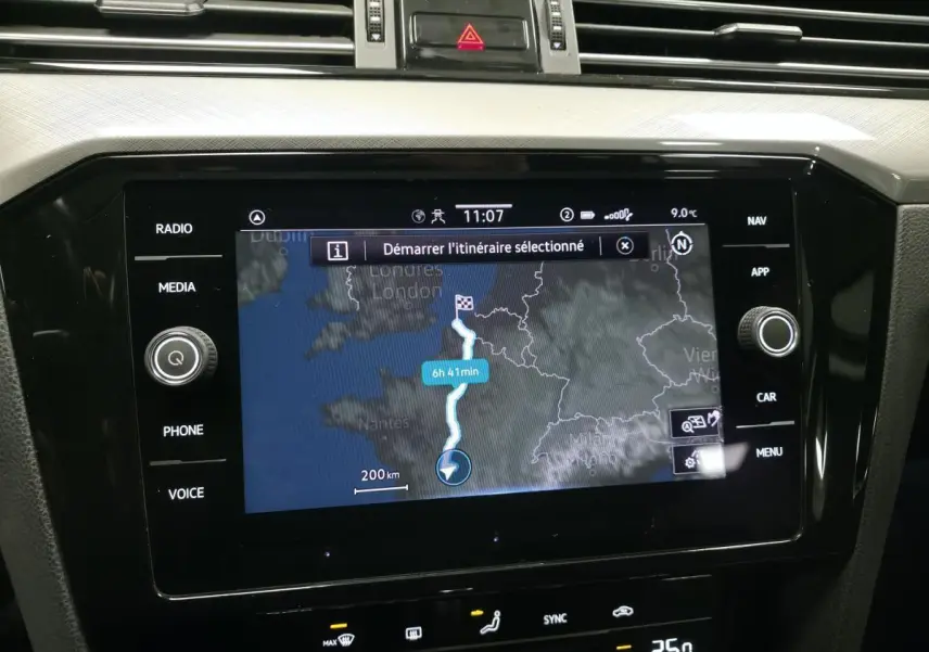 Écran tactile central de navigation de la Volkswagen Passat SW gris, affichant un itinéraire sur carte.