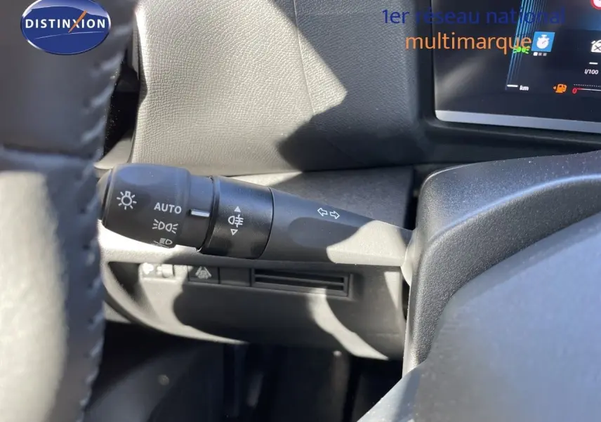 Détail du commodo d’éclairage à gauche du volant dans l’habitacle d’une Citroën C4 bleu Eclipse Metal 2026.