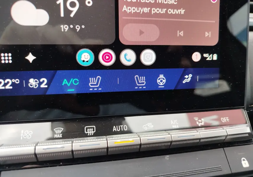 Gros plan sur l'écran tactile et les commandes de climatisation du Renault Symbioz 2025 en bleu Iron Metal.