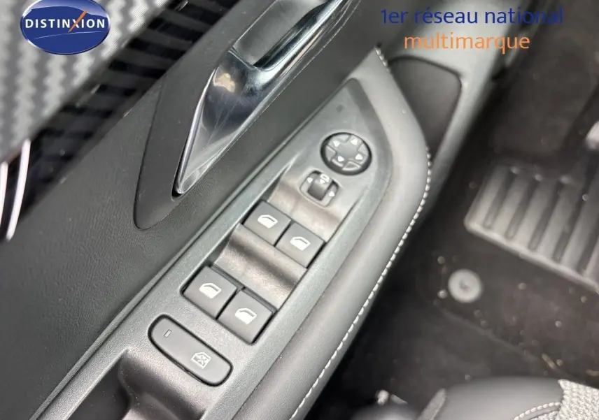 Gros plan sur la commande des vitres électriques côté gauche de la Peugeot 208 électrique gris Artense, avec poignée chromée.