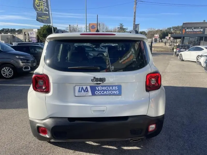 Vue arrière d'un Jeep Renegade blanc de 2019, avec feux arrière carrés et plaque "Véhicules Occasions".