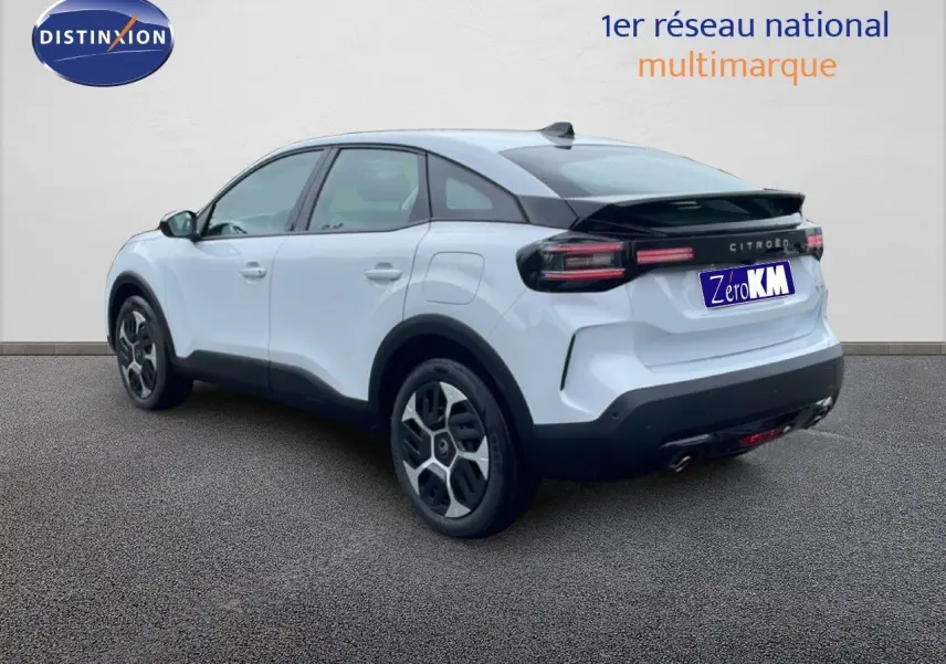 Vue 3/4 arrière droite d'une Citroën C4 blanche métal avec toit noir et feux arrière LED distinctifs.
